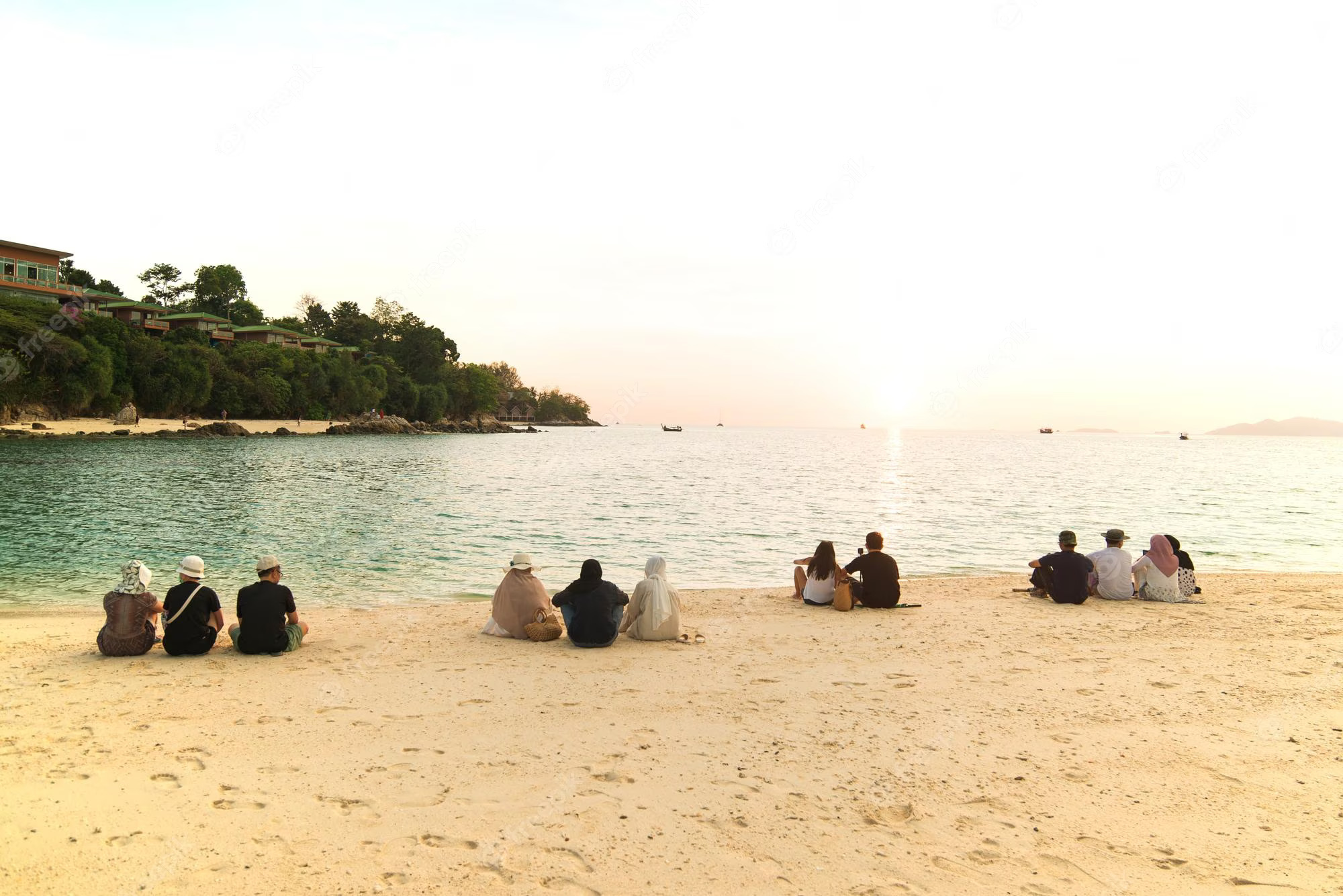 many-people-sitting-beach-looking-sun-sunset-time-travel-relax-concept_42534-1063